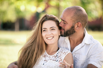 Obraz premium Happy Couple is Embracing Outdoors in Summer