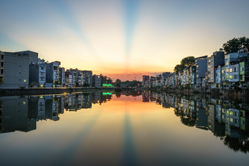 Naklejka premium Hanoi cityscape at sunset. Resident buildings by Tien Bien lake, Gia Lam district