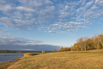 Fototapeta na wymiar Quiet lake with reeds, sunset on the lake