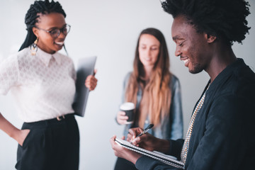 Mixed race group of businesspeople brainstorming in meeting