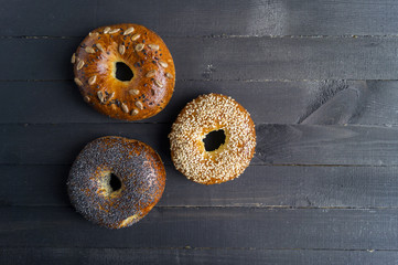 Bagels with seeds on a black background.