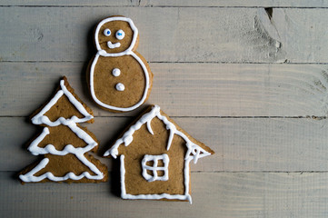 Christmas gingerbread cookies on wooden background.