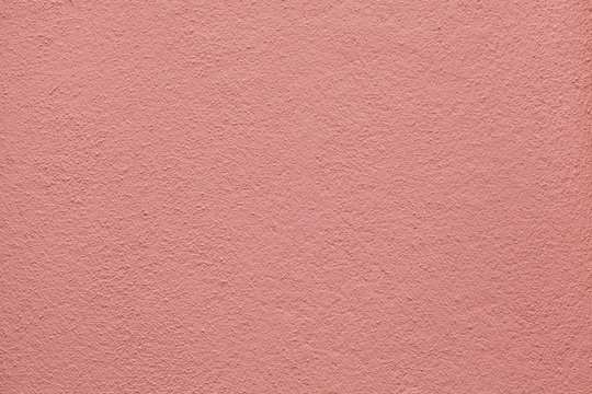 Pink painted stucco wall. Background texture