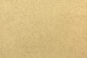 Yellow painted stucco wall. Background texture