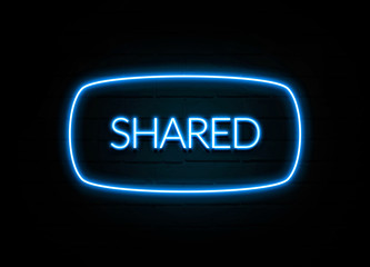 Shared  - colorful Neon Sign on brickwall