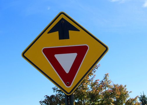 The Yellow Warning Yield Sign On A Close Up View.