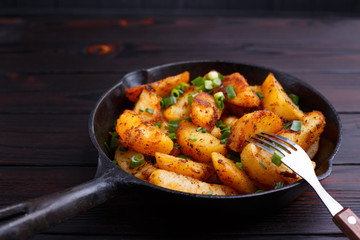 Appetizing countryside dinner. Eating delicious roasted potatoes. Home food close up
