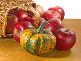 Apples and pumpkin in a basket