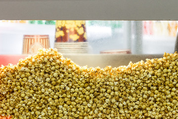 Transparent showcase filled with popcorn. Background.