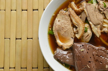 boiled duck meat and blood in brown Chinese herb soup on bowl