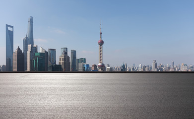 Empty road surface floor with city landmark buildings of Shanghai Skyline