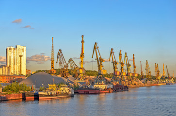 Fototapeta na wymiar Cargo cranes in port