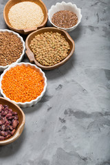 Healthy grains groats in wooden and ceramic bowls