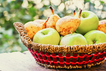 Fruits on wooden table in wicker basket