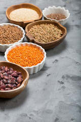 Healthy grains groats in wooden and ceramic bowls