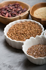 Healthy grains groats in wooden and ceramic bowls