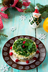 Fototapeta na wymiar Homemade snacks on a festive Christmas table. Fish salad with mushrooms, salmon, cranberries and cheese.