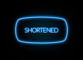 Shortened  - colorful Neon Sign on brickwall
