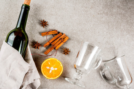 Christmas hot drinks recipes, Set of ingredients for mulled wine: wine bottle, spices, orange. Gray stone background,Top view space