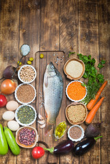 Healthy food ingredients for cooking concept diet fresh raw fish with vegetables and grains