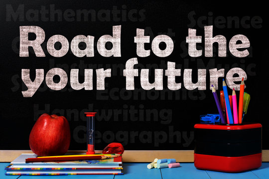 Text Road to the your future on black chalkboard with school accessories