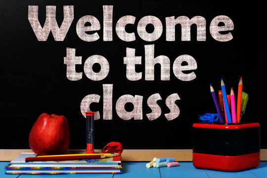 Text Welcome to the class on black chalkboard with school accessories
