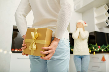 The couple gives presents in the room for Christmas.