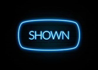 Shown  - colorful Neon Sign on brickwall