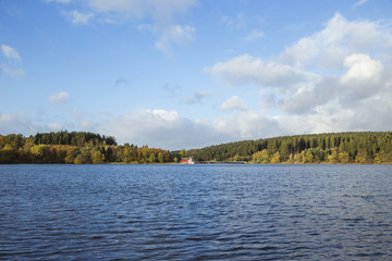 Haus am See mit Booten am Steg