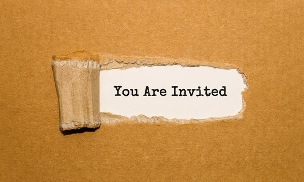 The Text You Are Invited Appearing Behind Torn Brown Paper