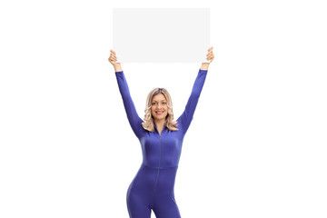 Woman in a racing suit holding a blank signboard © Ljupco Smokovski