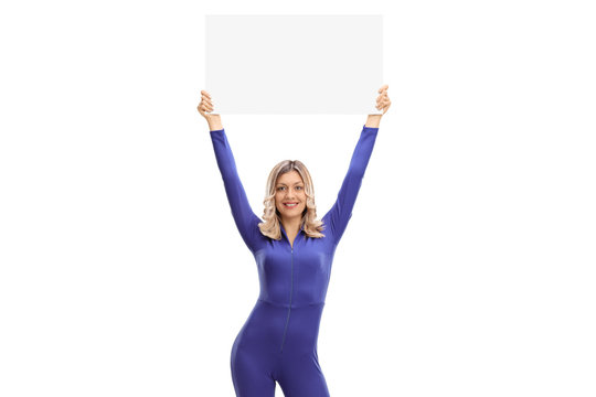 Woman in a racing suit holding a blank signboard