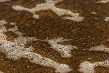 close up of the sea water affecting the sand on the beach, sea waves calmly flowing sand, relaxing...