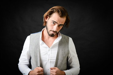 portrait of a handsome 30 years old young man isolated on a black background