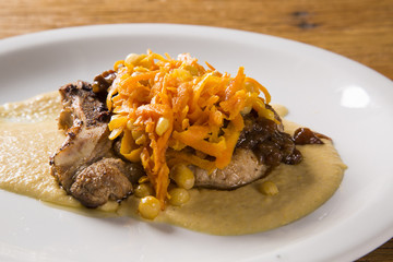 pork chop with barbecue sauce and corn musseline with carrot.