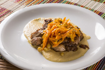 pork chop with barbecue sauce and corn musseline with carrot.