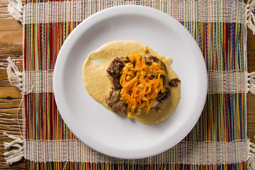 pork chop with barbecue sauce and corn musseline with carrot.