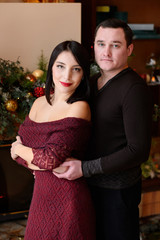 Happy family near the fireplace with New Year's decorations. Merry Christmas. Happy New Year.
