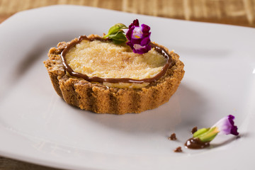 corn cheese cake with hazelnut cream in a white plate.