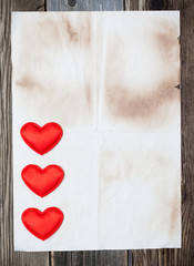 blank old paper with three red hearts