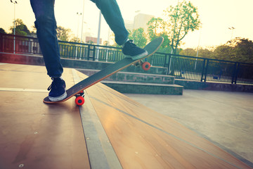 skateboarder legs skateboarding on skatepark ramp