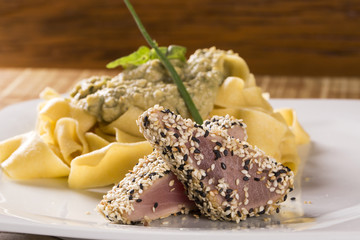 Fettucine pasta with white sauce and cod fish.