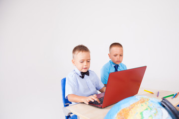 two boys sit at the computer training school