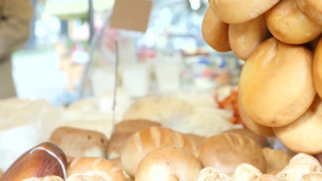 smoked cheese on the counter in the bazaar. 4k.