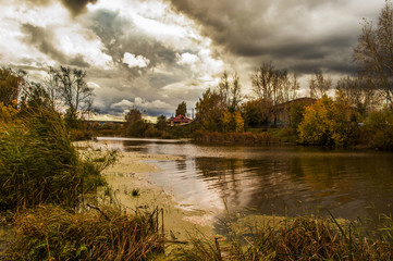 Autumn landscape beautiful lake near trees and houses