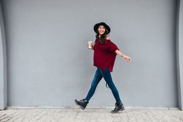 Full length portrait of a smiling joyful asian girl