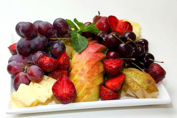 various sliced fruits on plate.
