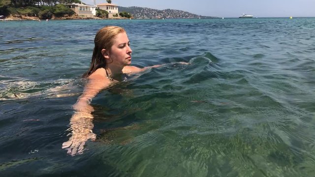 Swimming in blue French coast water slow-mo footage - Female in crystal clear sea slow motion