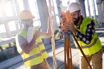 Portrait of construction engineers working on building site