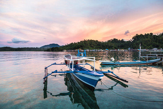 Stunning sunset over a traditional boat in Sulawesi